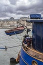 The Seine in Paris with the Louvre and a boat